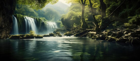 Tranquil creek displays majestic waterfalls creating a beautiful natural scene with copy space image