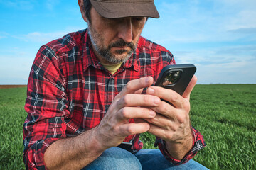 Farmer using smartphone app in modern smart farming concept