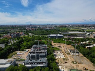 Aerial panoramic view of large construction site at sunny summer day. Construction of new buildings