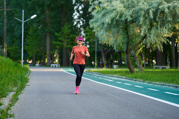 Athletic mature woman running in the park