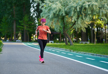 Athletic mature woman running in the park