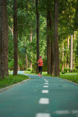 Athletic mature woman running in the park