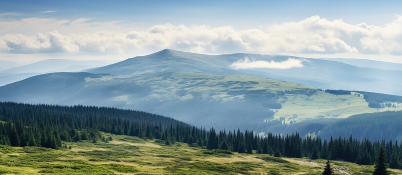 Scenic mountain slopes with forests meadows and cloudy skies on display in a view from the summit of Mount Hoverla featuring ample copy space image