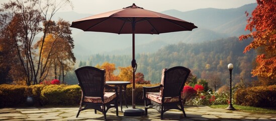 Outdoor chair with big umbrellas in a mountain resort hotel setting surrounded by a picturesque garden and lovely landscape in autumn providing a serene ambiance for relaxation with copy space image