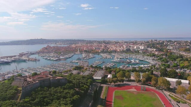 Antibes, France: Aerial view of Port Vauban Antibes and Antibes Marina in famous resort town by Mediterranean Sea on French Riviera - landscape panorama of Europe from above
