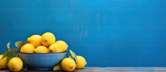 A vibrant scene with a big plate of colorful lemons on a blue table at a cafe featuring a copy space image - Powered by Adobe