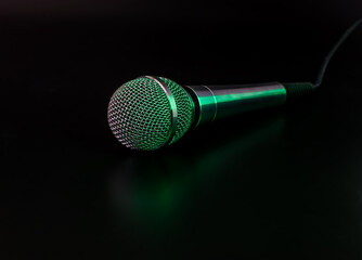 microphone on a black background with green backlight