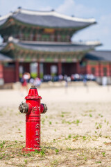 red standpipe, water supply or fire hydrant system on field for emergency purposes, Gyeongbokgong...