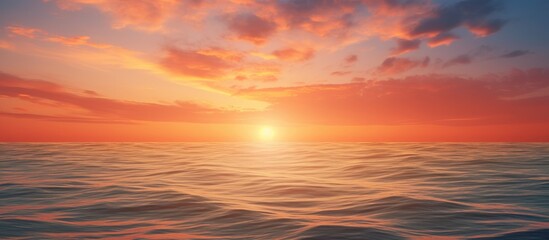 Obraz premium Orange clouds at sunset over the ocean creating a picturesque scene with a copy space image