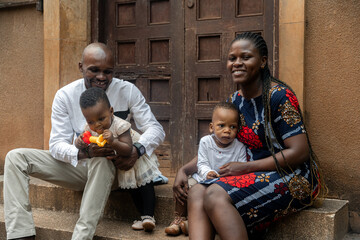 African family sitting in the entrance of a house