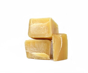 Pure natural Bees Wax (Beeswax) as it Comes Out of the Hive. Melted and Broken into Pieces. Used in Medicine, Cosmetics and Candle Making. Isolated on White. Beeswax wax heap isolated on white 