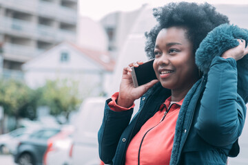 black woman talking on the phone in the street