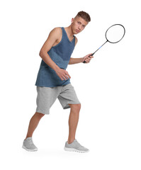 Young man playing badminton with racket on white background