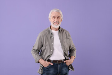 Portrait of stylish grandpa on purple background