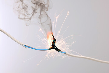 Sparking electrical wire on light background, closeup