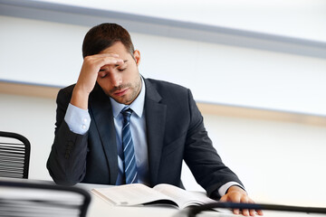 Tired businessman, headache and documents with stress in anxiety, fatigue or debt at office....