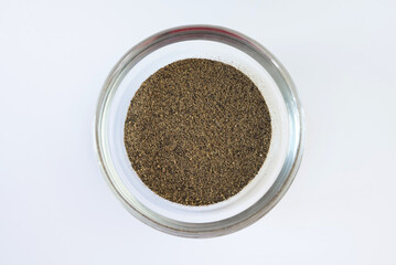 black pepper in a glass bowl closeup