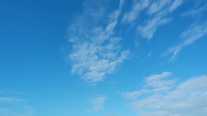 Fototapeta premium A clear blue sky with scattered white clouds. The clouds are thin and wispy, creating a delicate pattern against the bright blue background, conveying a peaceful and serene ambiance. 