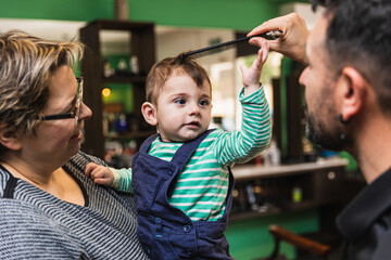 Toddler's first haircut at the barbershop