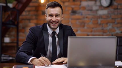 Fototapeta premium Confident Young Businessman Reviewing Financial Data on Laptop at Office Desk