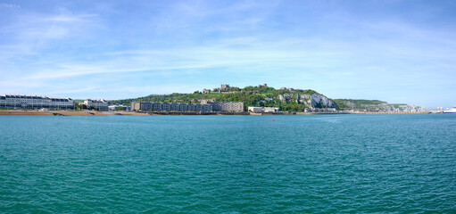 Fototapeta premium panorama of Dover coastline with harbor and castle, blue sky and calm sea