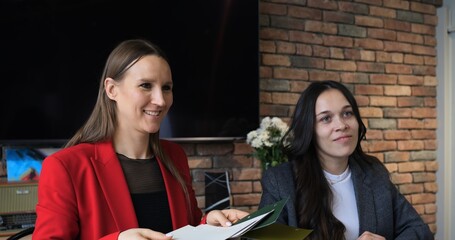 Designer in modern office, reviewing various material samples and color palettes for interior project. Engaging in creative discussions and detailed planning to achieve innovative design solutions.