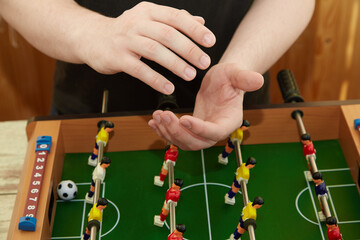 Hands applauding over the foosball table, Applause for the winner in the game, Playing foosball,...