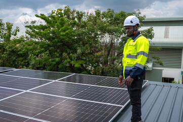 Expertise black solar engineer man working with solar panel installation on roof © Jack Tamrong