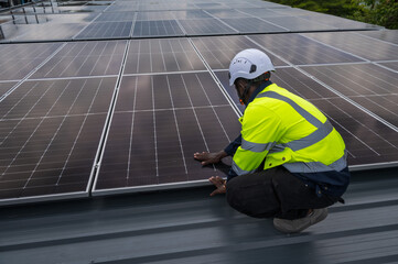 Expertise black solar engineer man working with solar panel installation on roof © Jack Tamrong