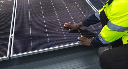 Worker carry solar panel preparing to install on roof