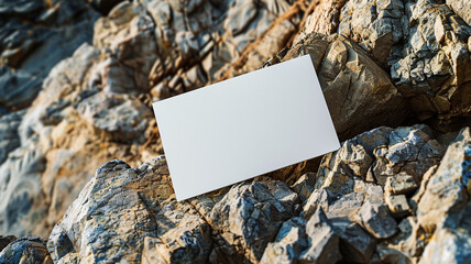 a blank white card mockup on rock shape