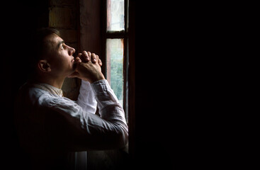 Praying man at the window