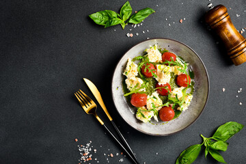 Spinach cream puree with cherry tomatoes and arugula. Cold snacks. In a plate.