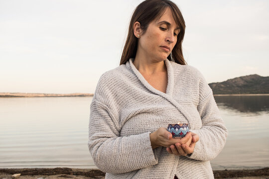 beauty woman holding blue candle. Meditation. Relaxation. aromatherapy. concept. Horizontal	