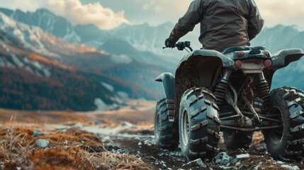 A man on a four-wheeler conquering a mountain peak. Suitable for outdoor adventure concepts - Powered by Adobe