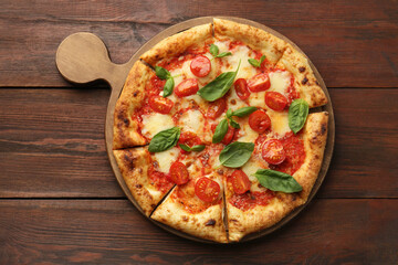 Delicious Margherita pizza on wooden table, top view
