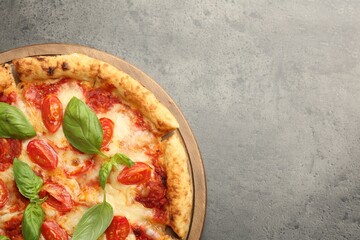 Delicious Margherita pizza on grey table, top view. Space for text