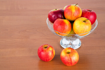 apples in a bowl on a table