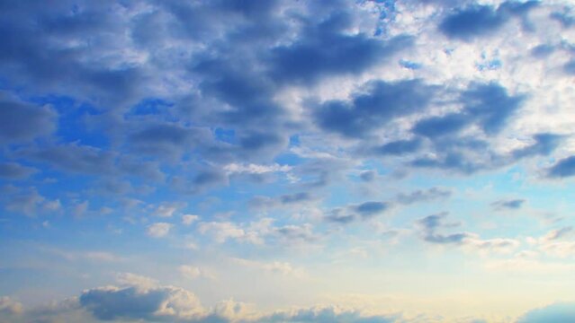 Clouds at different heights move in different directions. An unusual atmospheric phenomenon. The sky at sunset with a pink tint.