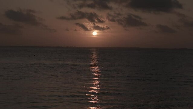 Peaceful tropical golden hour sunset glowing over Michamvi Kae shimmering Indian ocean, Zanzibar