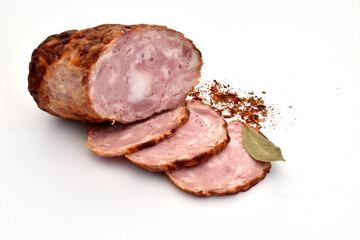 A piece of chopped meat sausage and several slices cut from it.