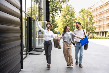 Career winner mindset. Group of young business people in front of office building. Confident...