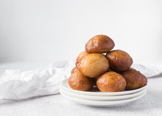 nigerian puff-puff on a white plate, nigerian fried dough balls, flatlay of homemade bofrot on white dish