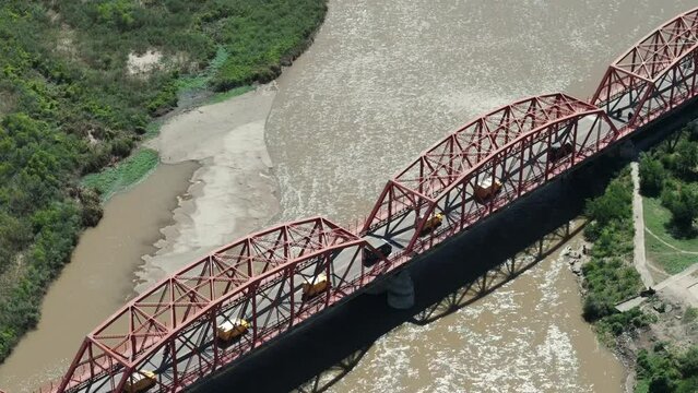 Money trucks crossing the Carretero Bridge in Santiago del Estero, Argentina.
