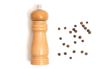 Wooden pepper mill on a white background. Cooking concept, top view