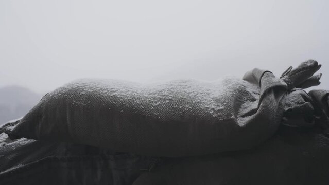 The closeup view of war trenches sandbags with snowfall from ww1 history.