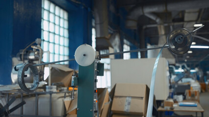 Metal strip rotates on industrial machine. Creative. Industrial machine with rotating coils and...