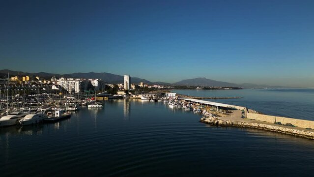 Mediterranean seascape and city of Estepona, aerial drone ascend view