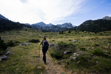 Young hiker woman in Vall de Boi, Aiguestortes and Sant Maurici National Park, Spain