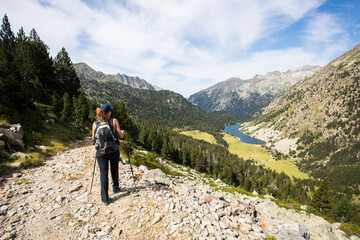 Fototapeta premium Young hiker woman in Vall de Boi, Aiguestortes and Sant Maurici National Park, Spain